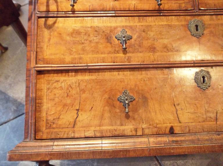 In transition from William and Mary, not unusual to skip periods like Queen Anne, a rather short one in both reign and style. Beautifully faded walnut burl veneers on top, front and sides. Unusually deep top flat surface (14 inches ).
Typical age,