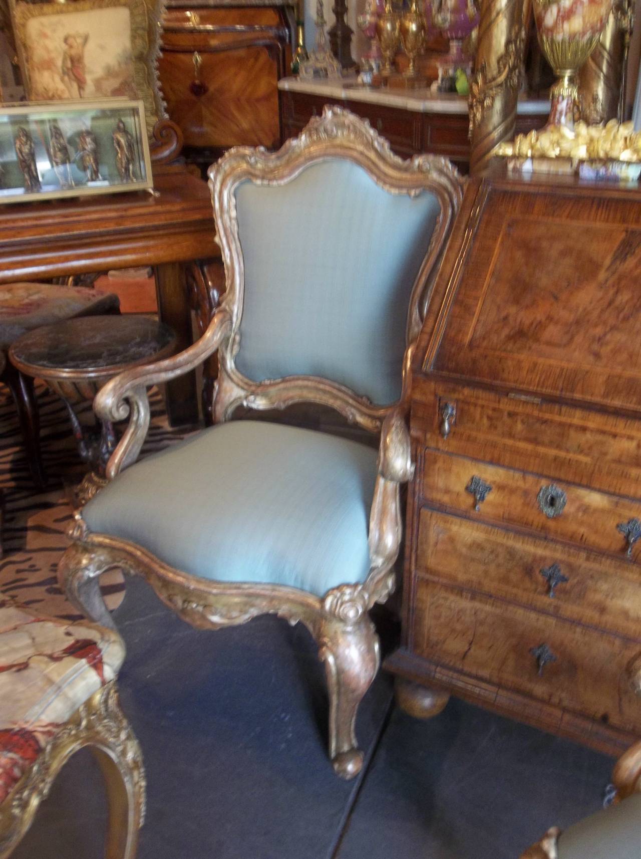 in transition from the baroque period . One chair circa 1750 and the second a later , probably 19th century, replica (common if one chair was destroyed ). Both in silver gilt ( argente ) with remaining traces of a Mecca Varnish.. with significant