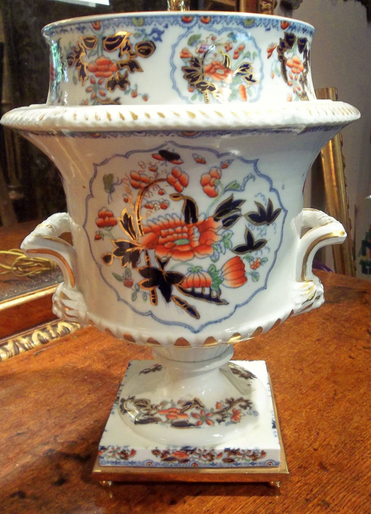 Any marking obscured by lamp conversion. Minor wear and rubbing to gilt trim, pitting to the white ground throughout . No chips or nicks .  Pretty blues, navy blues  and shrimp colors , typical of English porcelain . 

Urn :10.25 diameter 13.25