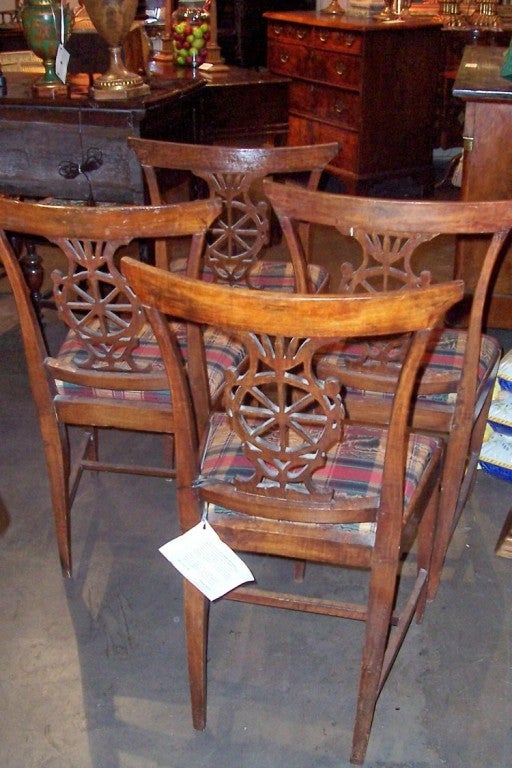 Rare set of four hand carved and peg constructed Italian neoclassical beechwood chairs , of slight Klismos form. Pretty well untouched (other than seat covering), no later screws or glue blocks and still all four are sturdy 
Very warm rich color and