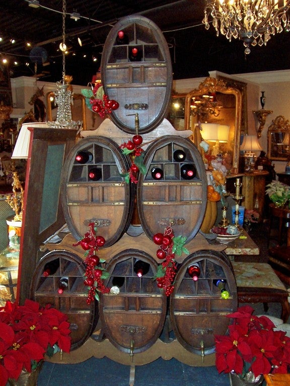 6 antique oak cognac / wine barrels adapted into wine storage rack . Configured on 3 racks 3-2-1-, each barrel with highly figured oak, carvings and brass fittings . Rich color , from private manor house in Avignon France.... Spickets are decorative