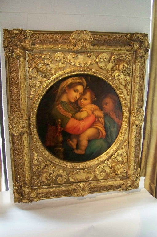 Splendid rendition of the ' Madonna and Child ' after Raphael's 1516 original. Lavish giltwood frame. Painting professionally restored .Oil (sight) diameter is 28.75 inches