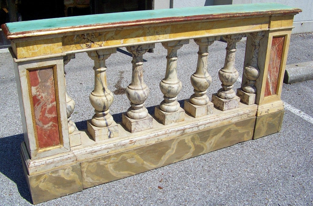An Italian (Venetian), maybe French, bedroom balustrade (used to separate the Mistress from the staff ) now a shallow or narrow console . Faux marble finished in varying colors and veining. The top in a green faux with a gold wash.