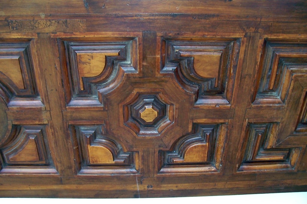 A walnut and fruitwood Tuscan door , later converted to a king bed (or Queen bed given current trend to oversize ) size headboard with old massive rings and chain . Unique geometric patterns. Nice old luster / patina  and contrasting warm cognac