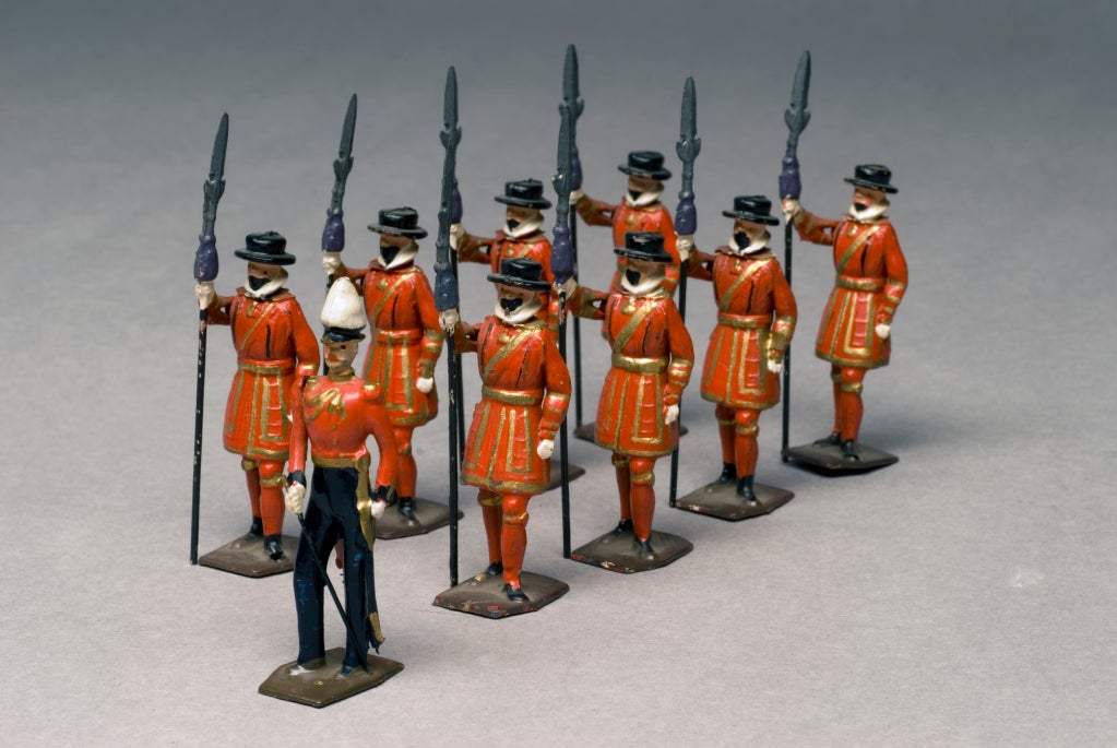 Britains Ltd. Set #1257, Yeomen of the Guard (Beefeaters), consisting of eight troopers in Tudor uniforms and one officer in Victorian uniform (all original and accurate). 

The yeomen wear knee-length scarlet tunics with gold pleats and gold