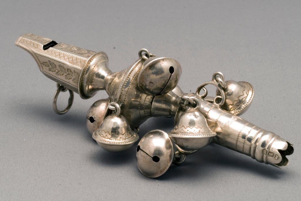 George III sterling silver baby rattle with eight bells and a nanny whistle, missing the coral teething stick, and with elaborate chasing. There are three hallmarks for sterling silver, London and the year 1807, but there is no maker's hallmark.