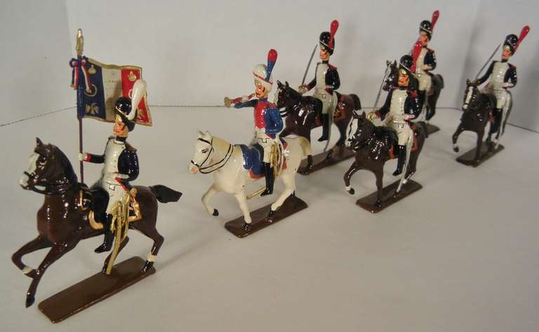 C.B.G. Mignot 6-piece set #211: Mounted Grenadiers of the Guard (1809) in dark blue tunics with orange/red facings. The set includes one standard bearer with a white plume and on a rearing horse, one bugler in a sky-blue tunic with orange/red
