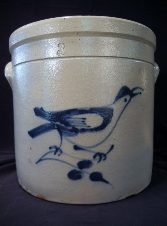Three-gallon, salt-glazed stoneware crock decorated with a cobalt blue, slip-quilled large singing bird perched on a crab-apple tree branch. There is a number 