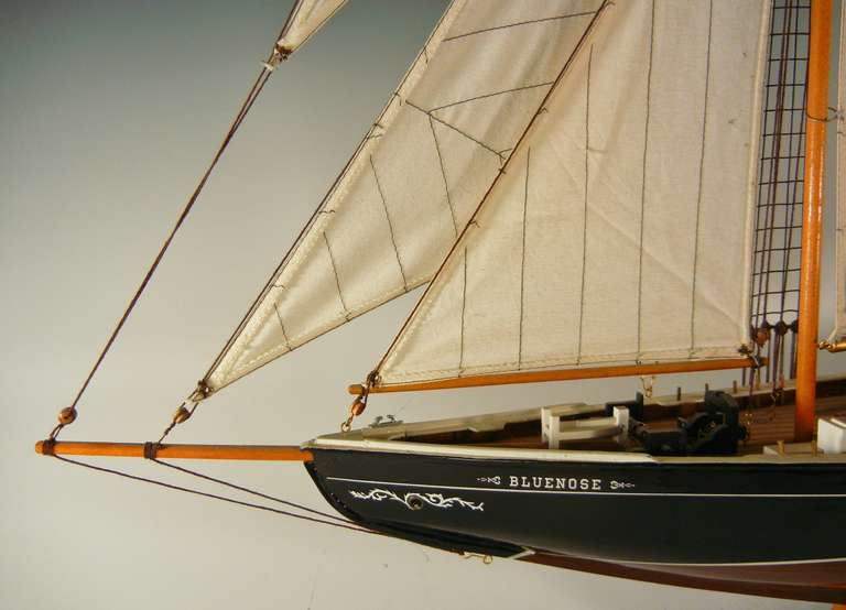 This excellent ship's model depicts the celebrated Canadian fishing/racing schooner Bluenose at full sail. it is hand-painted and assembled in accurate detail, and all parts are intact, including the rigging. It flies the Canadian red ensign, used