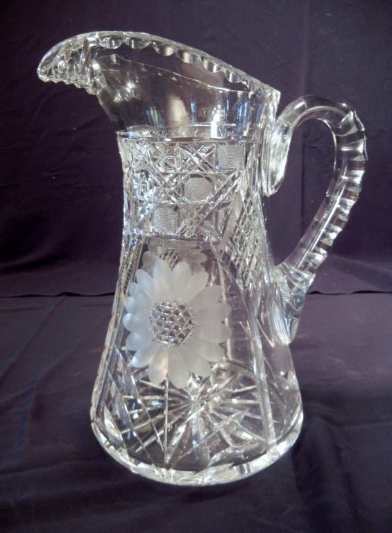 Exquisite American Brilliant Period blown and cut glass water/claret jug with applied handle and cut in sunflowers, diamond grids and diaper patterns, and with a star-burst base. Unsigned, c. 1880-1900.
This is a perfect heirloom wedding or