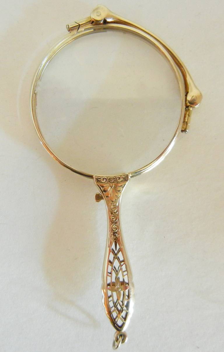 This Gilded Age 14-karat white gold, snap-open or fold-close, lady's lorgnette is designed to wear as an accessory around the neck for reading theatre or opera programs and menus in dark restaurants. It folds neatly to place in the purse as well,