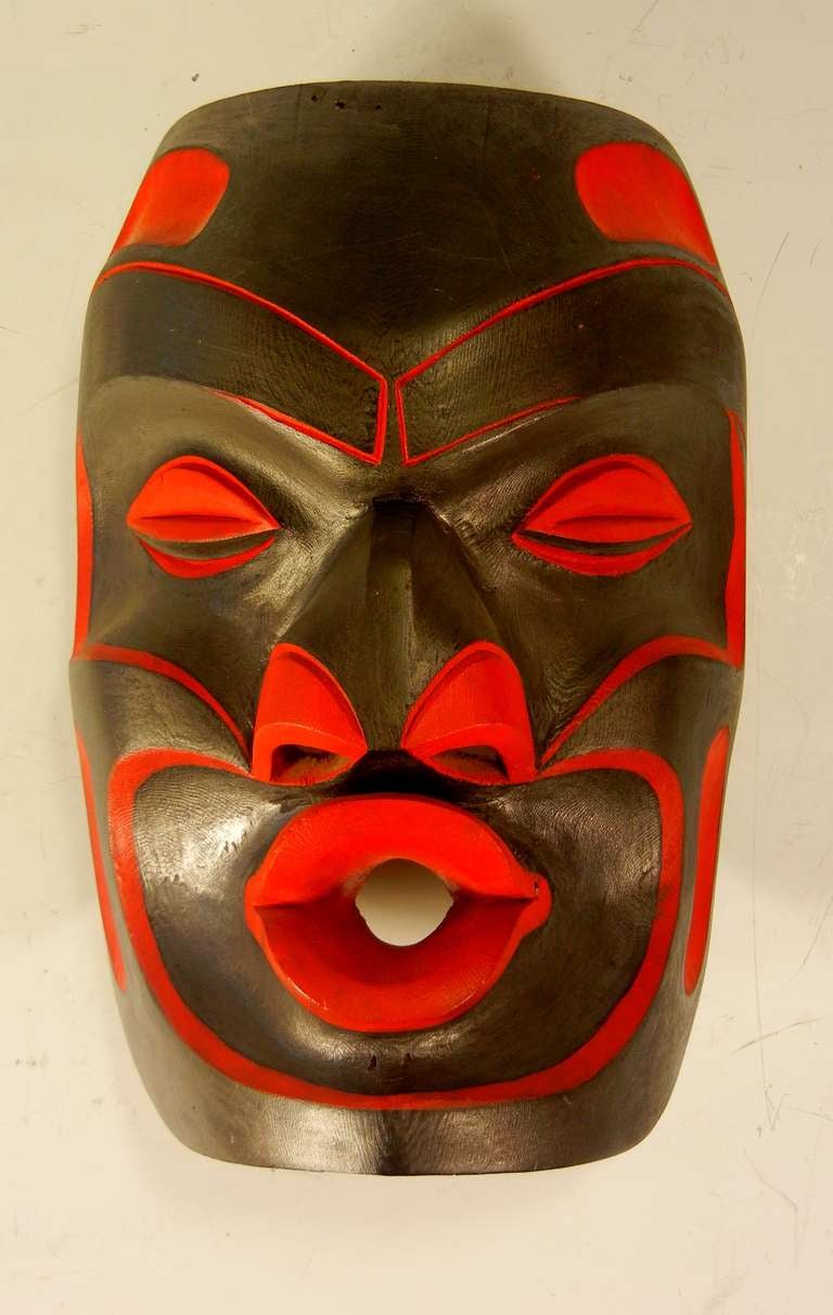 This ceremonial dance mask depicts Tsonokwa, the Wild Woman of the Woods. It is carved red cedar with red paint and graphite, and it is signed and dated April, 1987 by the Kwakwaka'wakw artist Andrew Coon of Gilford Island, British Columbia. The