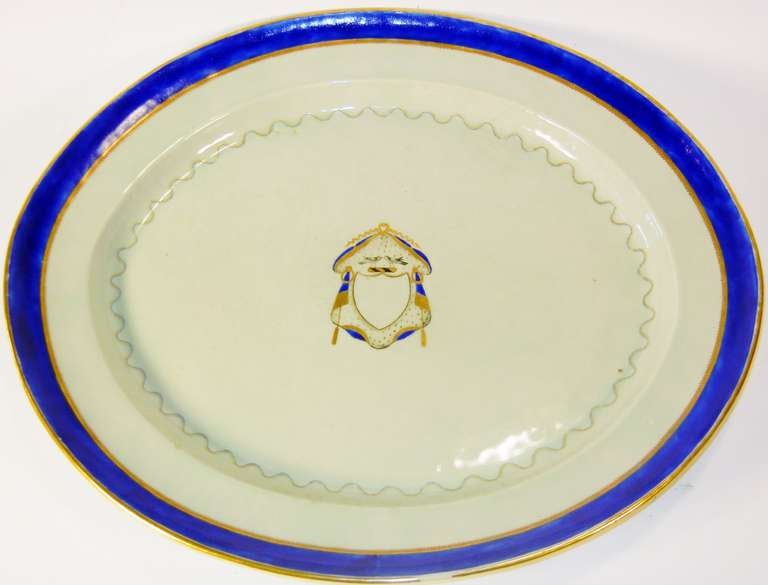 This rare size Chinese export platter was made for the American market of the Federal Period. The decoration is simple and refined and highly symbolic.

It has edging of a thick cobalt blue band between two gold strips, with a running swag pattern