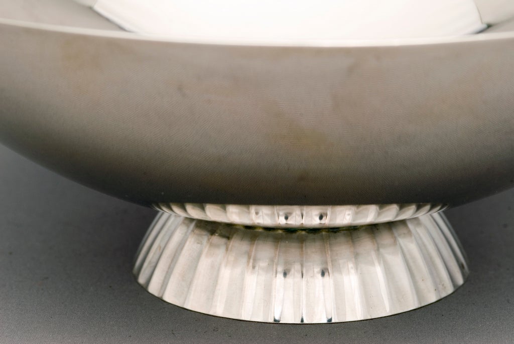 Sterling Silver Modernist bonbon bowl designed by Count Sigvard Bernadotte (1907-2002) for Georg Jensen Silversmithy, with spun body on a hand-chased fluted base and with a stylized hand-chased flower in the center of the bowl. Jensen Catalog number