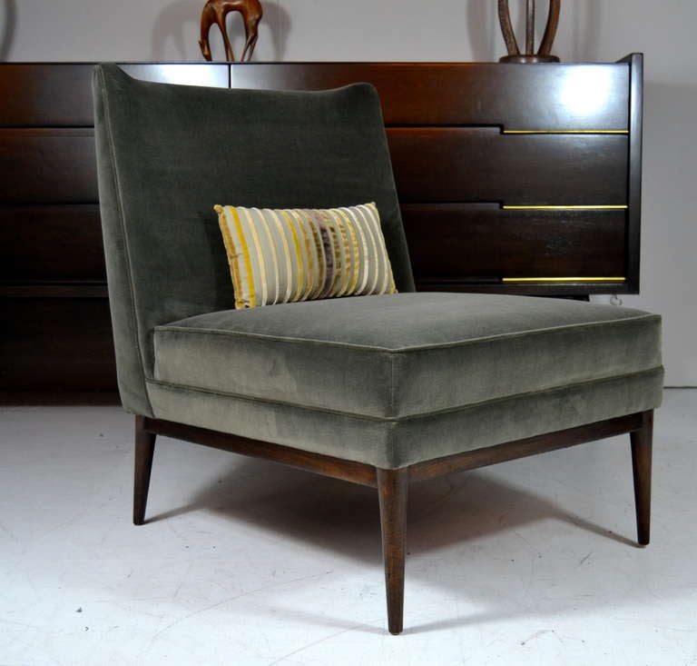 Classic pair of lounge chairs designed by Paul McCobb for Directional. Newly upholstered in a very handsome ash velvet and refinished in dark walnut with a French polished finish.
