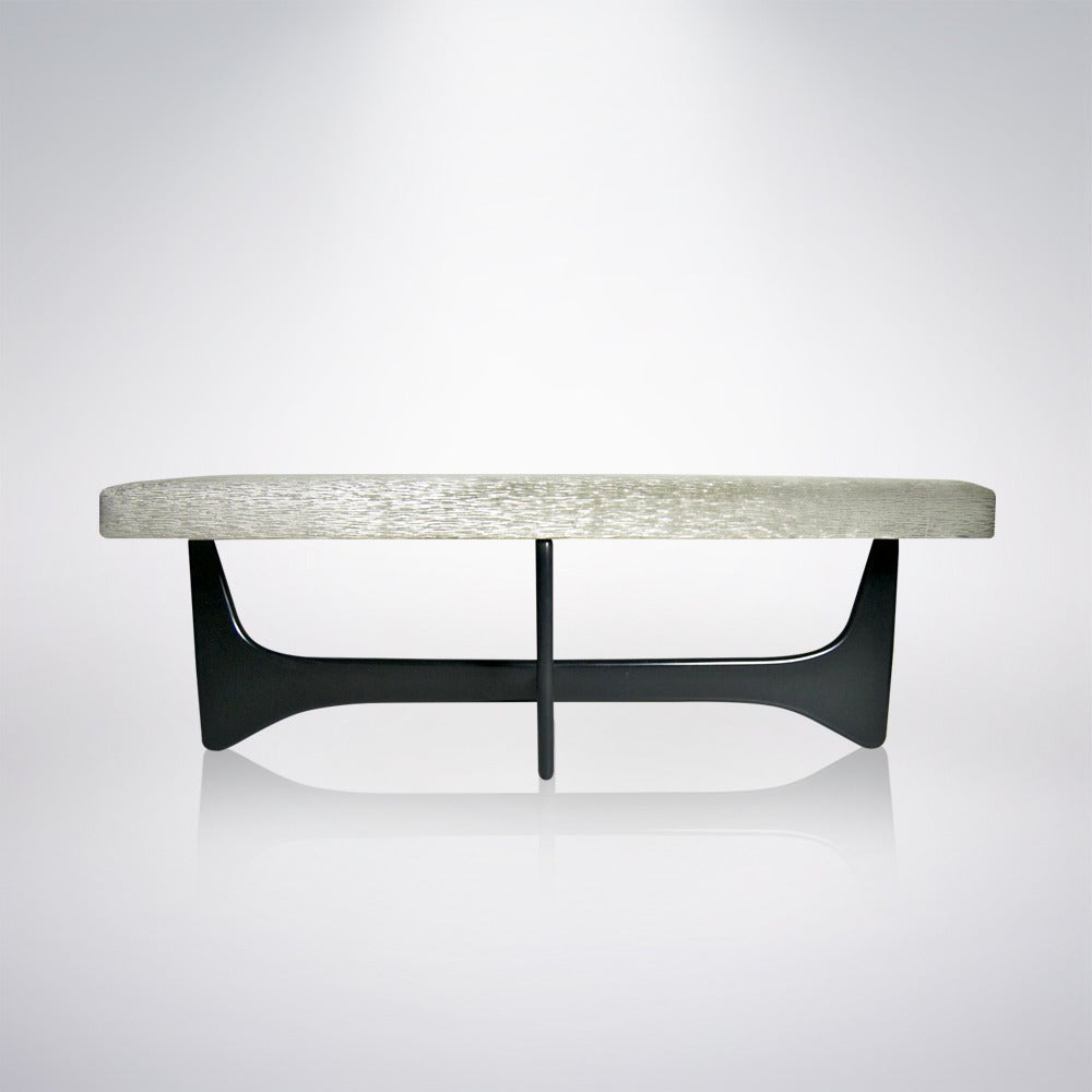 A Mid-Century Modern bench featuring a sculpted base in the manner of Vladimir Kagan. Newly done in ebony as well as reupholstered.