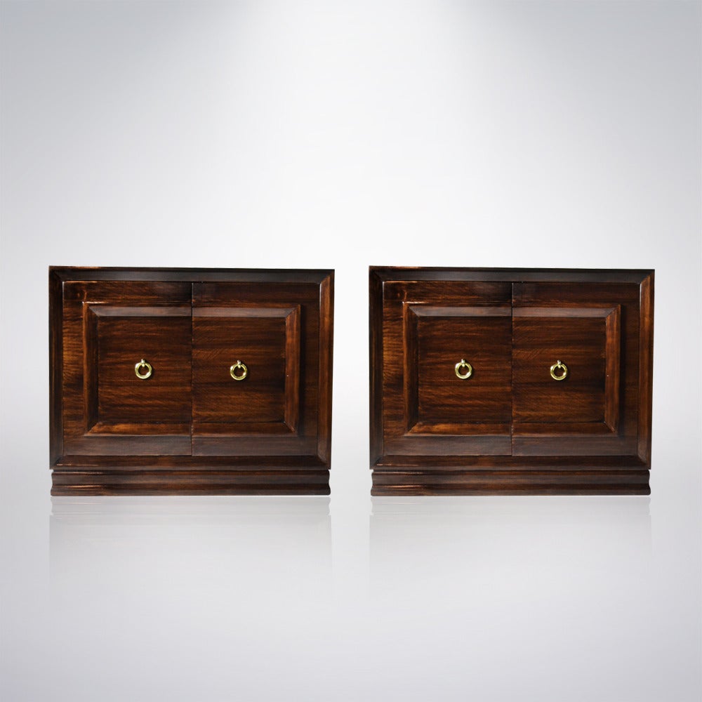 Stunning pair of tiger maple chests of drawers designed by Paul Laszlo. This pair features doors highlighted by brass knocker pulls that open up to reveal three drawers for ample storage space. Newly refinished.