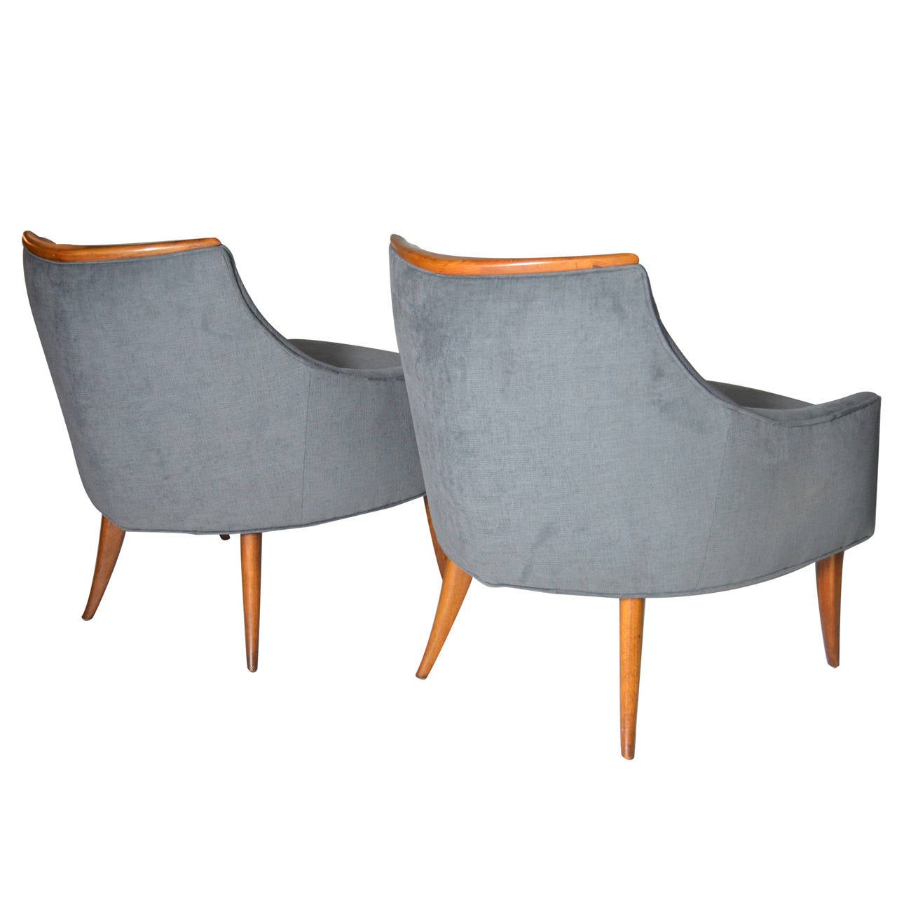 Stunningly pair of Danish Modern lounge chairs. This pair features a rare boomerang-shaped teak wood trim, and saber legs. Newly upholstered in grey chenille.