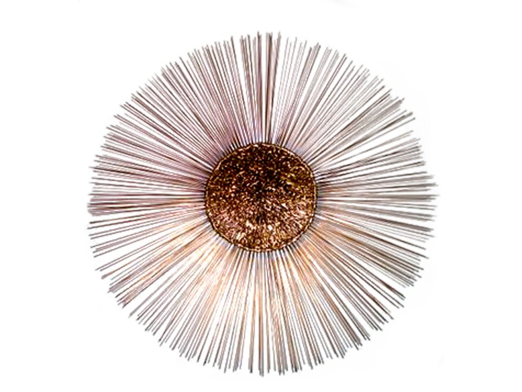 Colossal sunburst wall sculpture attributed to Curtis Jere. Nicely executed all around, its center is formed of irregularly melted mixed metals. At almost 4 feet in diameter this is surely a one of a kind.