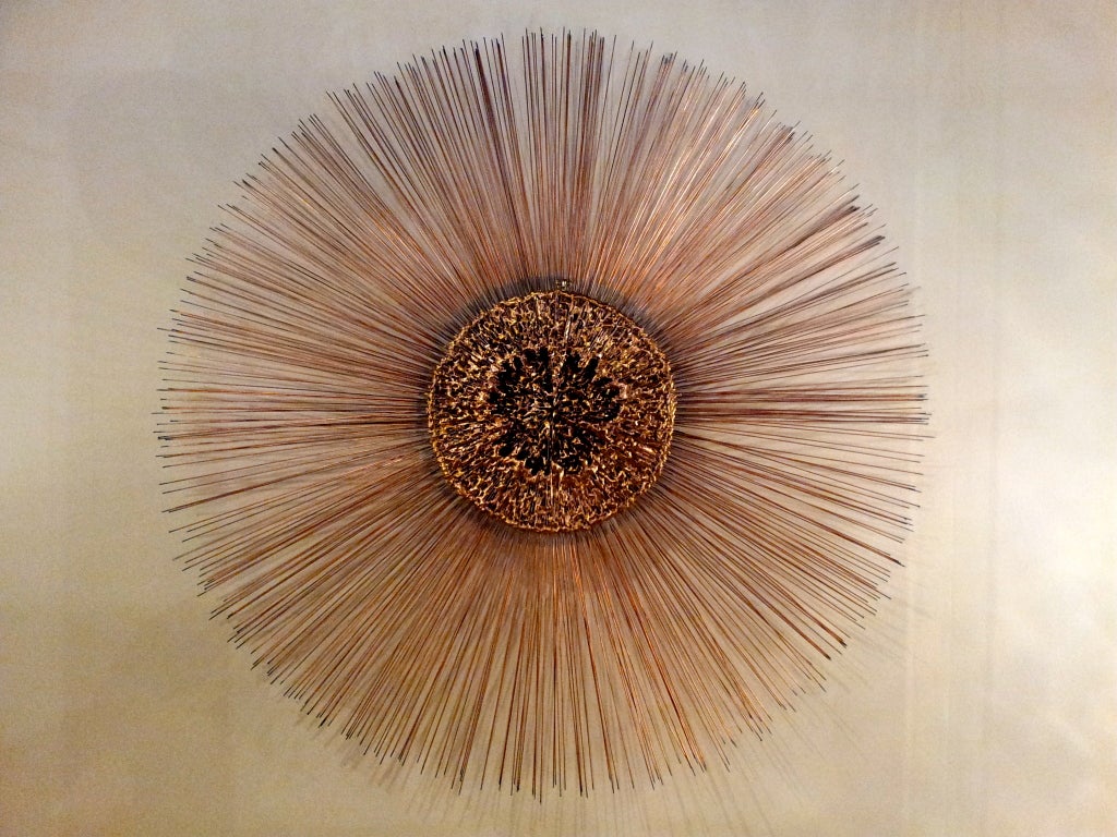 Colossal sunburst wall sculpture by Curtis Jere. Nicely executed all around, its center is formed of irregularly melted mixed metals copper, bronze, brass, w/ double layered copper rods. At almost 4 feet in diameter this is surely a one of a kind.