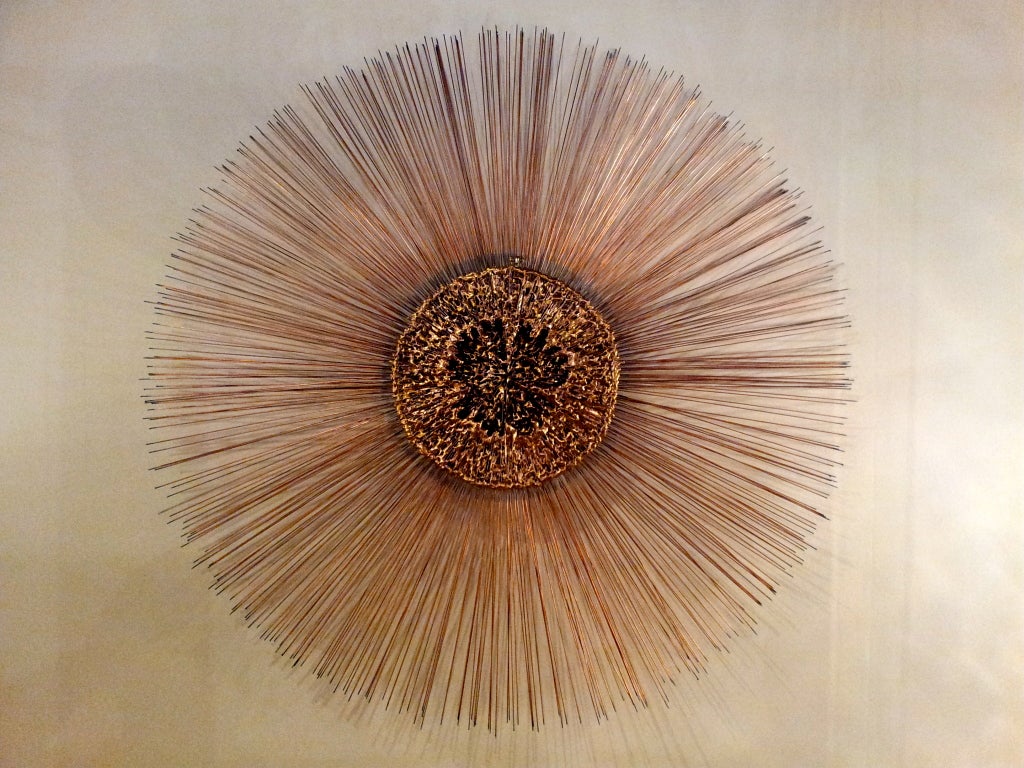 Colossal sunburst wall sculpture by Curtis Jere. Nicely executed all around, its center is formed of irregularly melted mixed metals copper, bronze, brass, w/ double layered copper rods. At almost 4 feet in diameter this is surely a one of a kind.