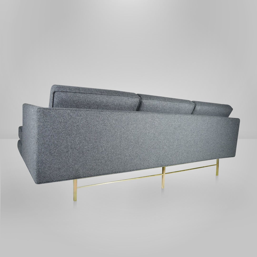 Rare brass base sofa in the style of Paul McCobb for Directional. Newly upholstered in a dark grey wool.