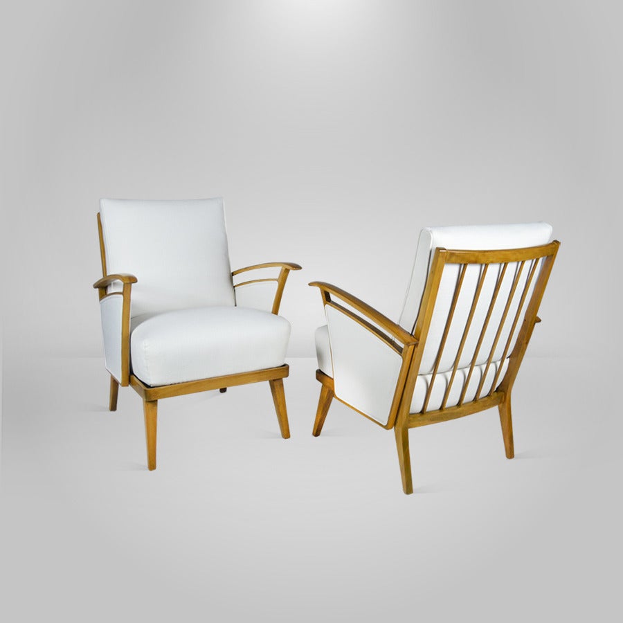 
A pair of beautiful Mid-Century Modern Italian lounge chairs after Ico Parisi. Walnut frames newly refinished in a tanned tone as well as re-upholstered in white linen.

