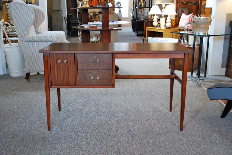 Modern rosewood desk in the style of Paul McCobb, beautifully complimented by six polished brass conical pulls.