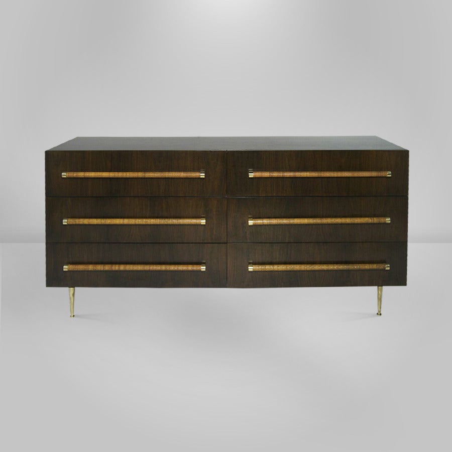 Classic six drawer dresser or chest of drawers on brass legs designed by T.H. Robsjohn-Gibbings for Widdicomb. 

Six drawers provide ample storage space, each drawer is highlighted by long caned handles ending in brass accents.

Nicely restored