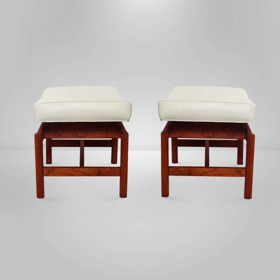 A pair of teak stools or benches designed by Jens Risom for Jens Risom, Inc., circa 1950s.

Newly upholstered in an oatmeal tone leather. Teak frames fully restored.