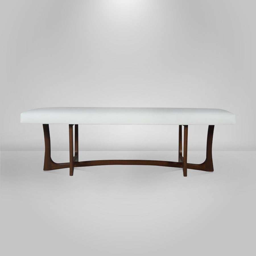 Mid-Century Modern sculptural walnut bench. Newly refinished in a medium. Custom top done in a white faux leather.