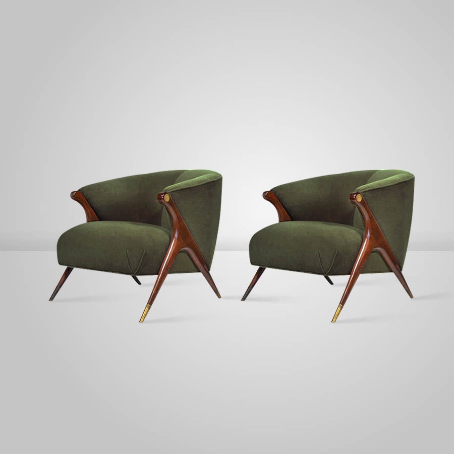 Pair of modern lounge chairs, manufactured by the Karpen Company of California, circa 1950s. They have been completely restored, with sculptural wooden legs refinished in a medium walnut tone, hand polished brass sabots as well as newly upholstered
