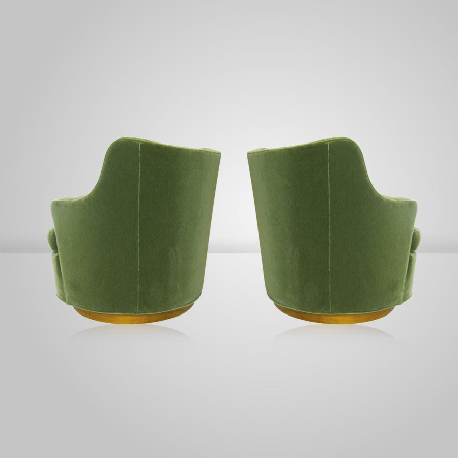 Pair of swivel chairs designed by Edward Wormley for Dunbar model 4626, circa 1950s.

Newly upholstered in green mohair, walnut veneer base refinished in medium walnut.
