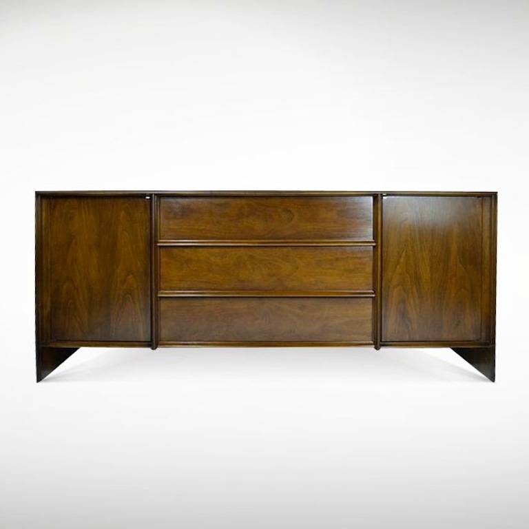 Classic floating credenza by T.H. Robsjohn-Gibbings newly refinished in medium walnut.
