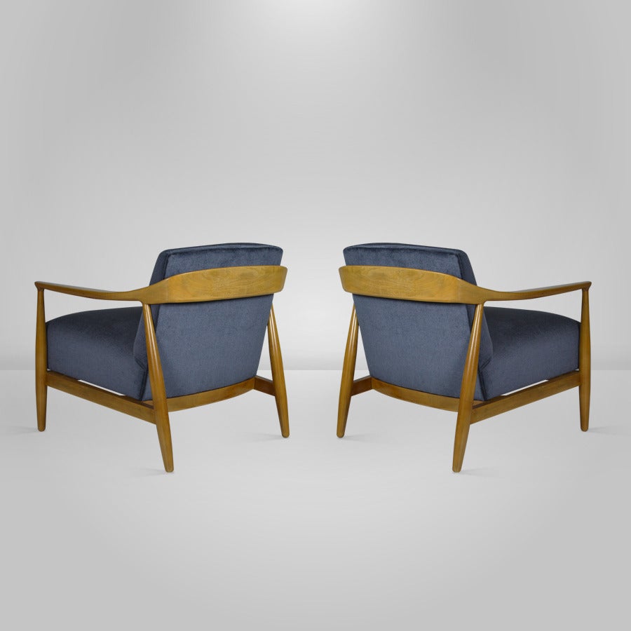 Pair of lounge chairs designed by Ib Kofod-Larsen. Bleached walnut frames newly restored and in mint condition. Newly upholstered in navy blue velvet.

COM / COL available.