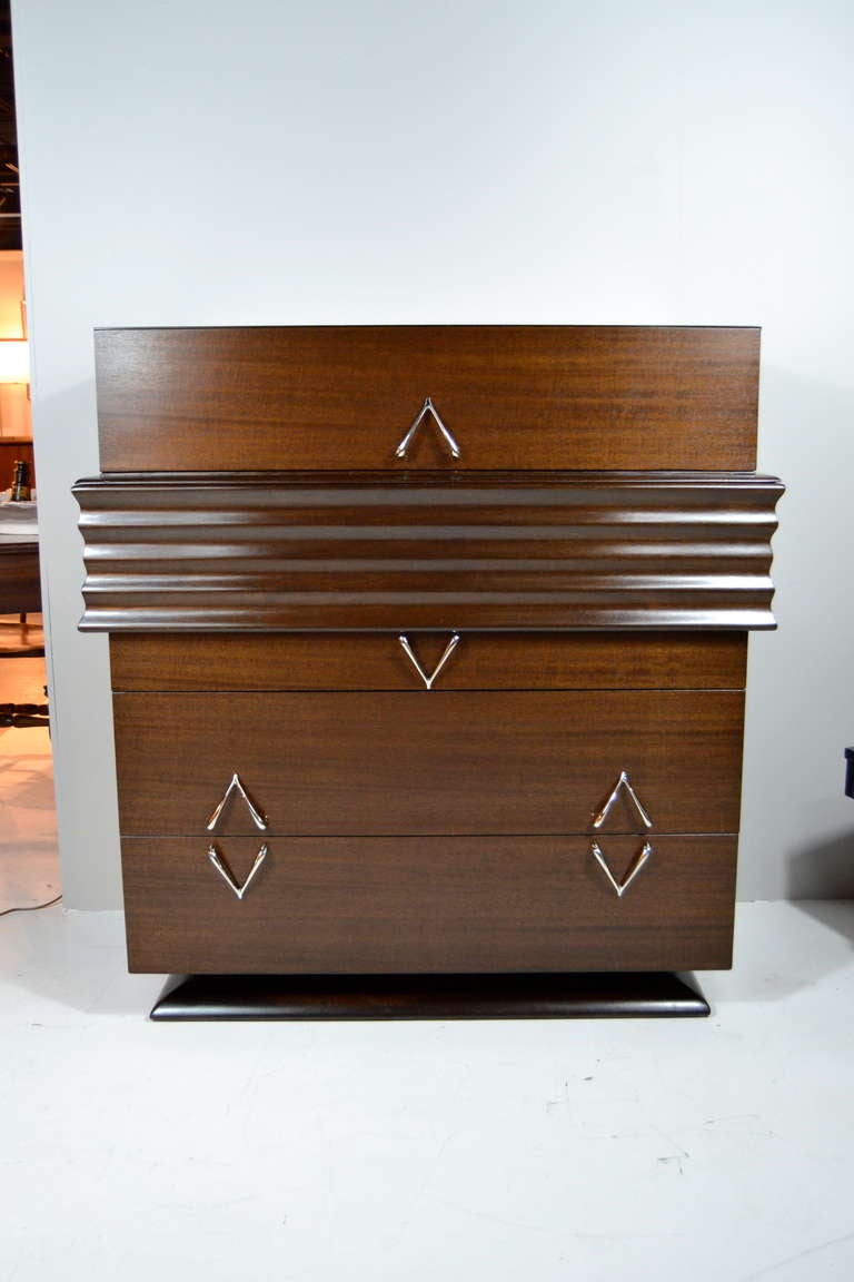 Art Deco style Mid-Century gentleman's dresser newly refinished in dark walnut. Five drawers for ample storage space and wishbone shaped nickel-plated hardware.