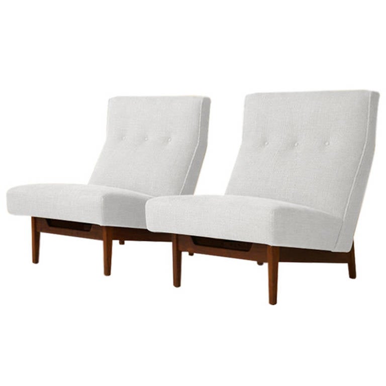 Pair of lounge or slipper chairs designed by Jens Risom for Jens Risom, Inc. Newly Upholstered in high grade white Italian linen. Sculptural walnut base newly refinished in natural.