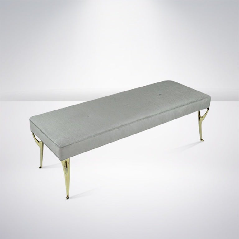 Fabulous bench original from Italy, circa 1950s. Newly upholstered in grey chenille. Featuring very unusual sculptural, newly polished, solid brass legs.