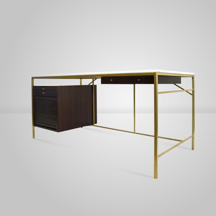 Extremely rare designed by Paul McCobb model C8815 for Calvin Grand Rapids The Irwin Collection.

Desk features one pull-out work surface, three drawers and one tambour door concealing file storage. Signed with applied metal manufacturer's label