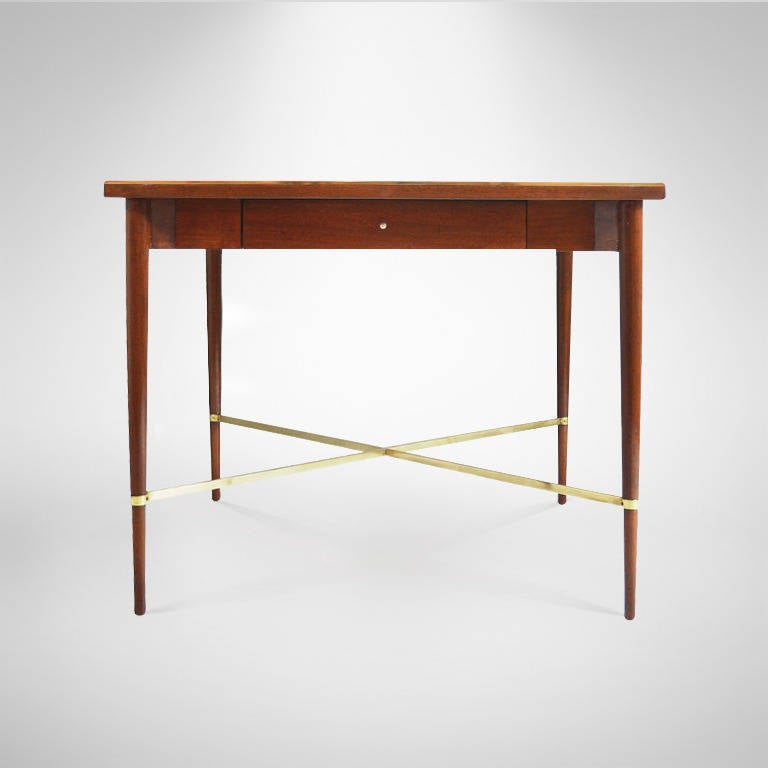 Games table designed by Paul McCobb featuring brass trim on top as well as brass stretcher. Top also features diamond shaped inlaid rosewood. Newly refinished in natural, brass newly polished.