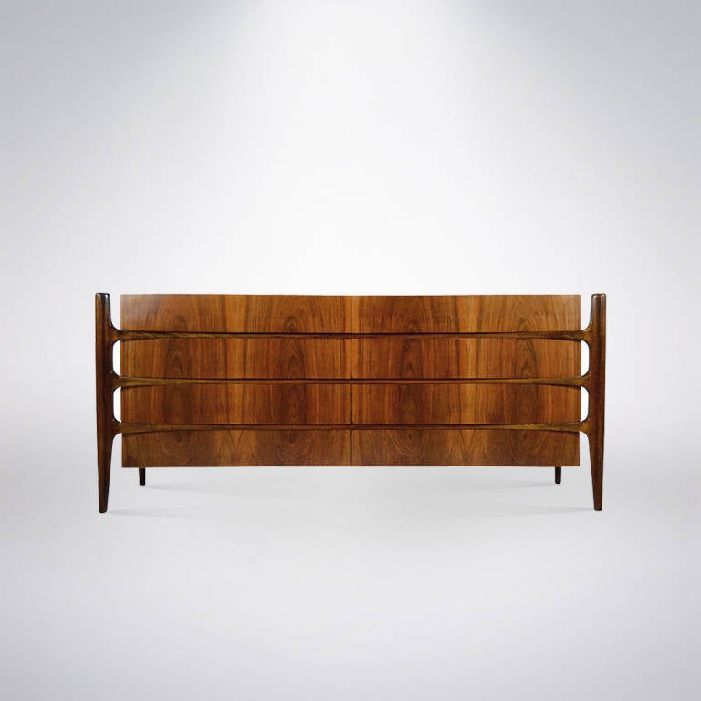 Rare rosewood sideboard or dresser by furniture designer William Hinn. Very unique exposed frames, this item features eight slightly curved front drawers. Providing ample storage space. Newly refinished and in mint condition.