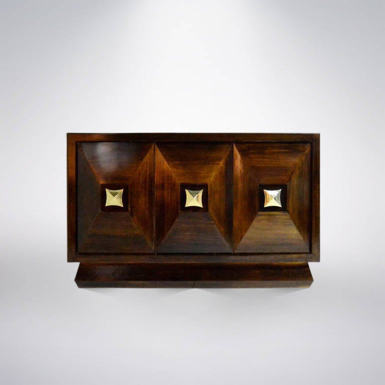 A handsome credenza in the style of Vladimir Kagan; made from sapele mahogany featuring rare multidimensional diamond front doors with heavy newly polished brass hardware. Newly refinished and in mint condition.