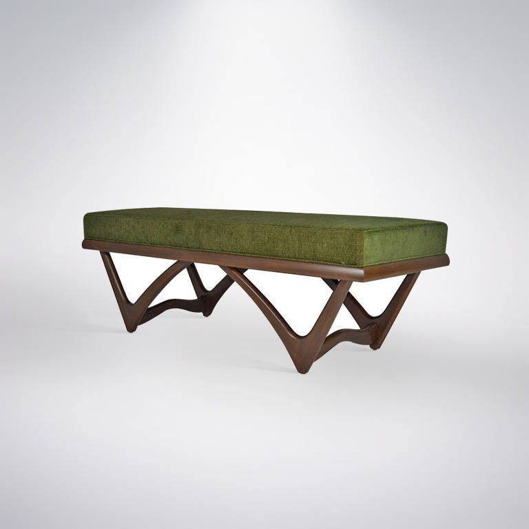 A fabulous bench featuring sculptural a W-shaped walnut base newly refinished in natural. Top has been newly upholstered in a fresh forest green chenille.