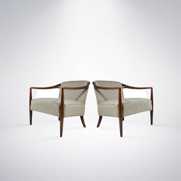 Pair of lounge chairs featuring sculptural walnut frames, newly refinished in medium as well as re-upholstered in a very fresh olive green fabric by Donghia.