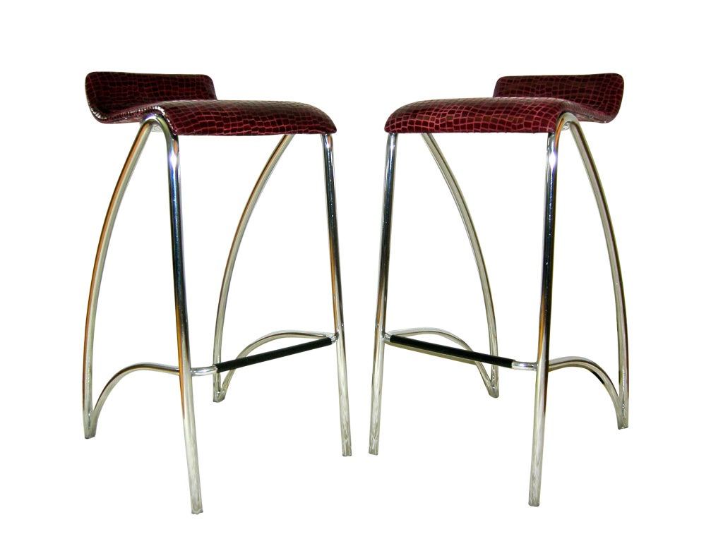 Pair of chrome cantilevered bar stools upholstered in burgundy alligator embossed lamb skin.