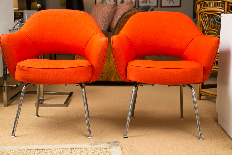 A pair of iconic 1960's Saarinen chairs newly upholstered in orange microfiber.