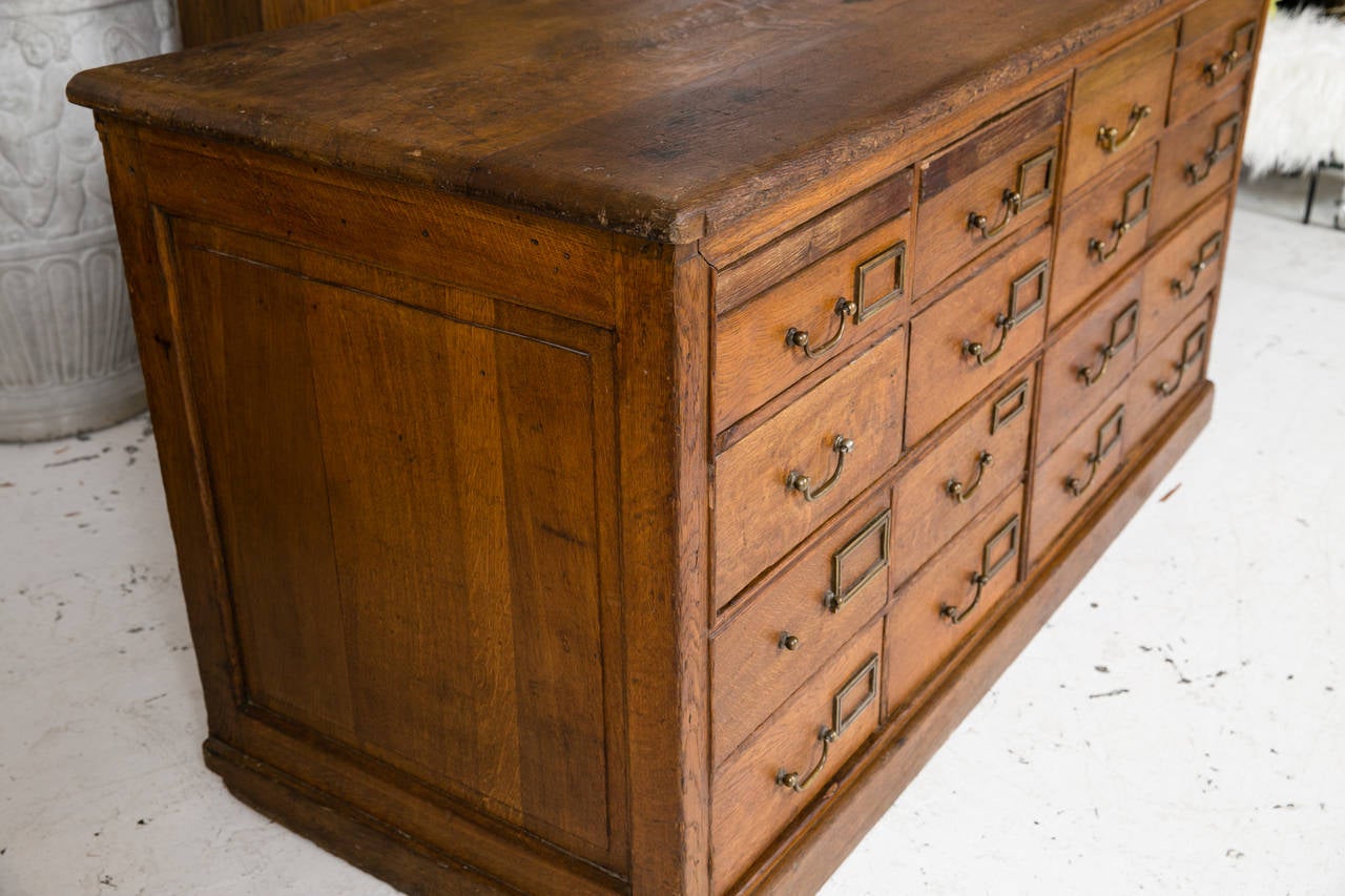 Exceptional British antique, solid oak library or postal cabinet in all original condition. Top four drawers are boxes which must be removed to open. A wonderful piece with a fantastic, worn soft patina. Purchased in Paris. Missing one pull.