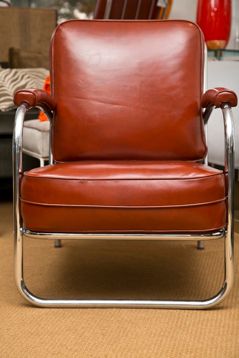 Senational Condition. This pair of  Deco/Moderne club chairs are just as comfortable as they are flawless. All original with Tobacco Leather like vinyl upholstery.