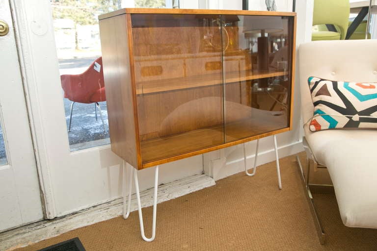 Unique mid-century display cabinet designed by Paul McCobb and part of his 1950's planner group collection-retro-fitted with white lacquered steel supports.
