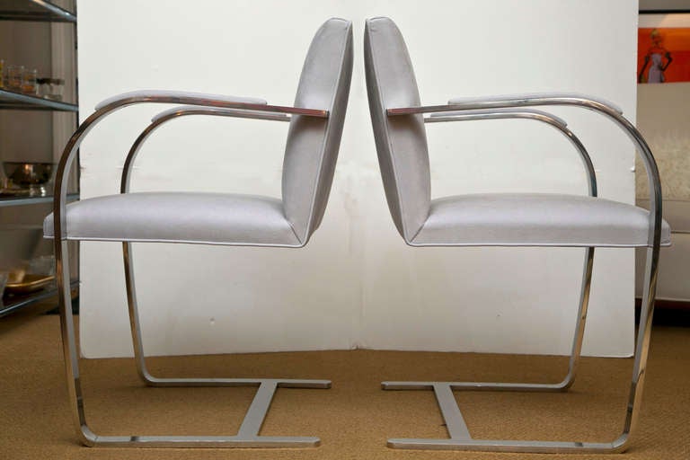 Mid-century iconic Classic Ludwig Mies van der Rohe Brno armchairs custom re-upholstered in a light gray ultra-suede. Pad arms. Mirror polished finish.